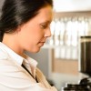 Baristas prepare coffee in well insured café or coffee shop